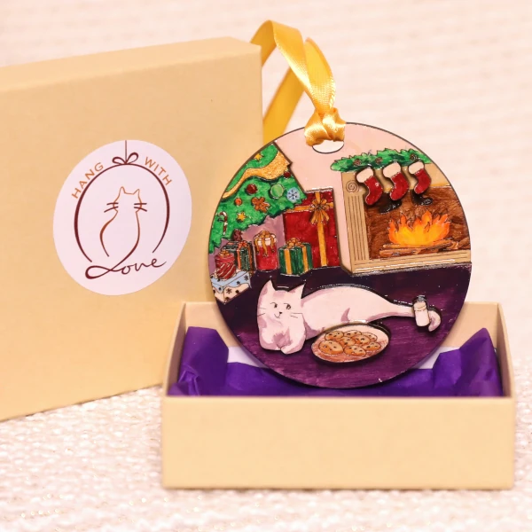 ornament placed in a gift box with lid right next to it
